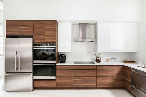 a kitchen with wooden cabinets and stainless steel appliances at Rooftop Condo in Nashville