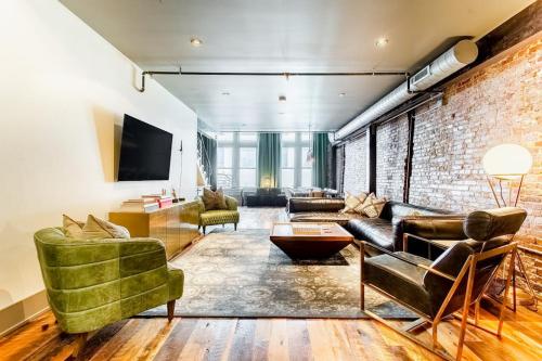 a living room with a brick wall at Tasteful Loft in Nashville