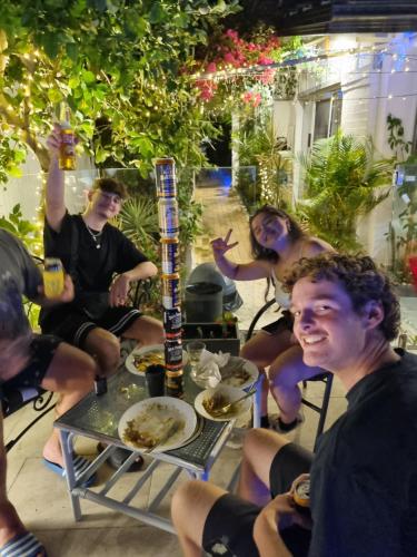 a group of people sitting around a table at Backpackers Homestay 21-36 yrs ONLY in Caloundra