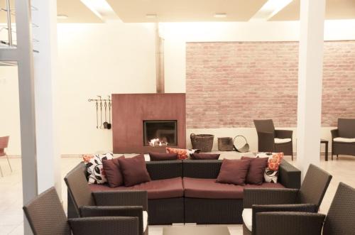 a living room with a couch and a fireplace at Penzion Solnice in Znojmo