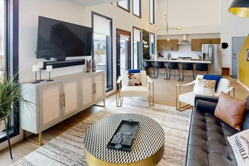 a living room with a couch and a table at Illume 407 in Nashville