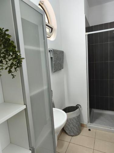 a bathroom with a toilet and a glass shower door at Oroklini by the pool in Oroklini