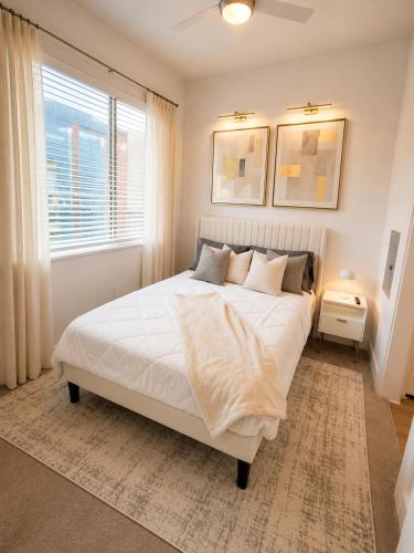 a bedroom with a white bed and a window at River Walk in San Antonio