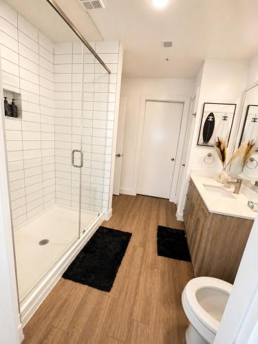 a bathroom with a shower and a toilet and a sink at River Walk in San Antonio