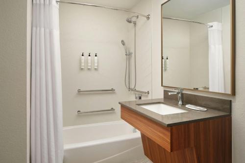 a bathroom with a sink and a shower and a tub at Fairfield Inn and Suites by Marriott Saint Augustine I-95 in St. Augustine