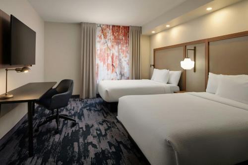 a hotel room with two beds and a desk at Fairfield Inn and Suites by Marriott Saint Augustine I-95 in St. Augustine