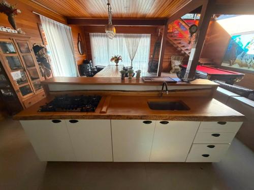 a kitchen with a counter top with a sink at Cabanha Tessaro in Chapecó