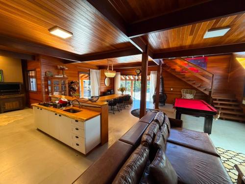 a large living room with a couch and a table at Cabanha Tessaro in Chapecó