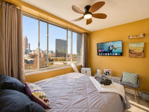 a bedroom with a bed and a large window at Beautiful 3BR Condo in DTWN Pool Access in Atlanta