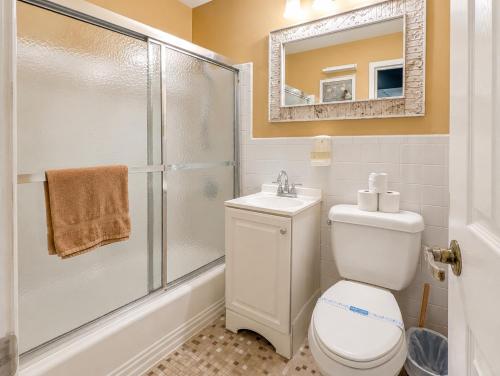 a bathroom with a shower and a toilet and a sink at Beautiful 3BR Condo in DTWN Pool Access in Atlanta