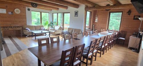 a large dining room with a large table and chairs at Przystanek Bieszczad in Lutowiska