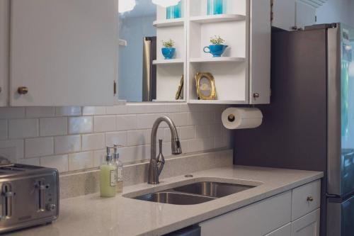 a kitchen with a sink and a refrigerator at Glenside Getaway in Muskegon