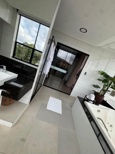 a bathroom with a sink and a bathtub and a tub at HOTEL TERRA NATIVA in Alter do Chao