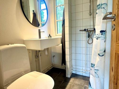 a bathroom with a sink and a toilet and a mirror at M27-Vaeggerlose-Tornbladvej-14 in Bøtø By