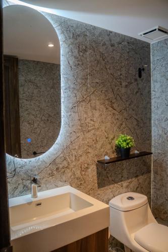 a bathroom with a sink and a toilet at Torogoz Home in San Salvador