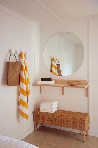 a room with a mirror and a bench with towels at The Mullet in Nambucca Heads
