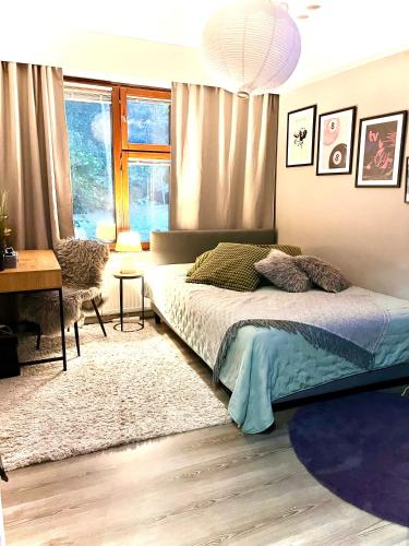 a bedroom with a bed and a desk and a window at Apartment for 5 people in Savonlinna