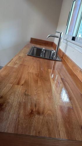 a kitchen sink on top of a wooden floor at Aurora - calle Del Sol in Santa Rosa