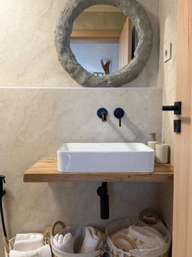 a bathroom with a white sink and a mirror at KUBIQ 2 Transalpina in Sebeş