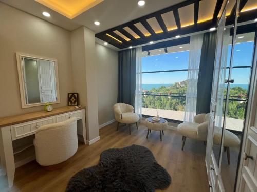 a living room with a large window with a view at cam teraslı köyevi in Cayeli
