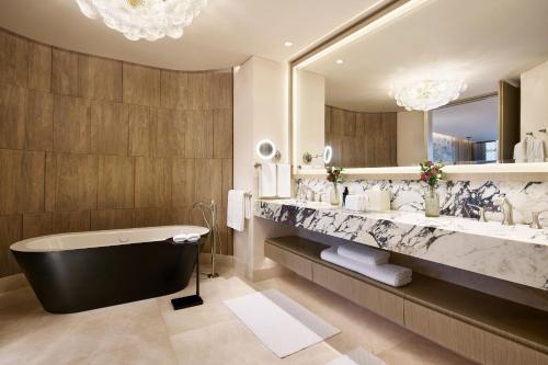 a bathroom with a tub and a large mirror at The St. Regis Mexico City in Mexico City
