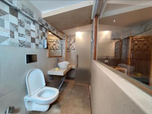 a bathroom with a toilet and a sink at The Town Boho in Shimla