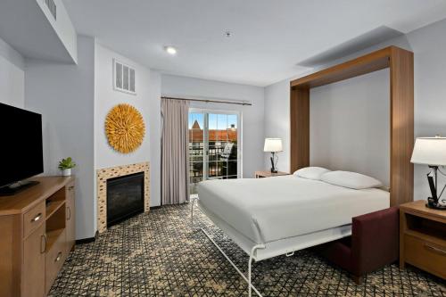 a bedroom with a bed and a tv and a fireplace at WorldMark Solvang in Solvang