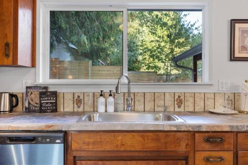 a kitchen counter with a sink and a window at Seattle cottage in Seattle