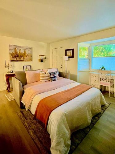a bedroom with a large bed with pillows on it at Seattle cottage in Seattle