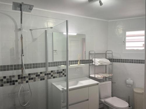 a bathroom with a shower and a sink and a toilet at Soleya Apartment in Quartier de Lorient