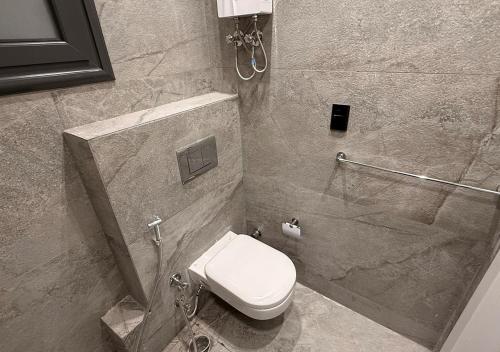a bathroom with a toilet and a shower stall at Panoramic Nile View 3BR Apartment in Cairo