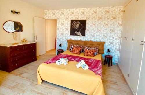 a bedroom with a bed and a dresser in it at Senhora da Rocha Sea View, Pool, Terrace in Porches