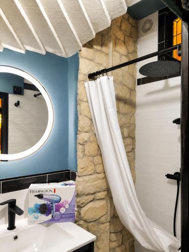 a bathroom with a sink and a shower curtain at La Mío Quintana in Corao