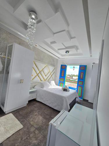 a bedroom with a bed and a chandelier at Casa Boutique Hotel in Salento
