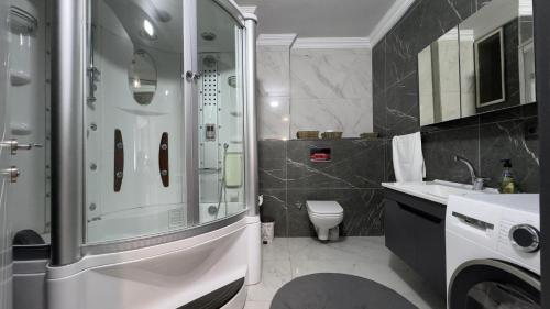a bathroom with a shower and a toilet and a sink at cam teras villa in Cayeli