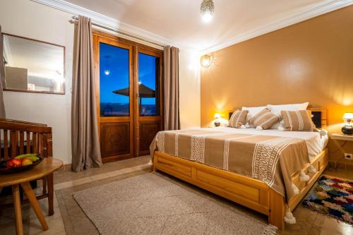 a bedroom with a large bed and a window at Villa de luxe Sakina in Essaouira