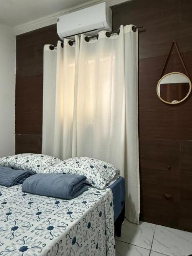 a bedroom with a bed with a curtain at Estadia rápida- Quarto 3 in Bayeux