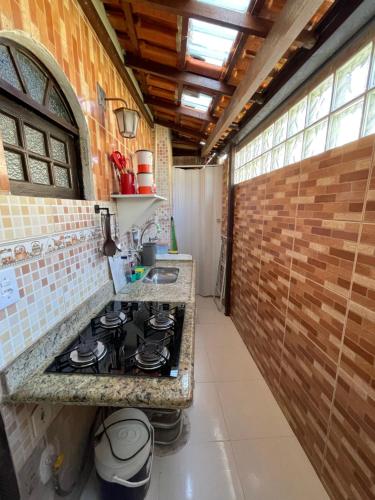 a kitchen with a stove and a counter top at Apartmento102 - Condomínio Brisa Mar in Cabo Frio