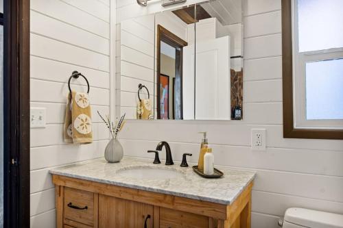 a bathroom with a sink and a mirror at Larks Nest in Big Bear Lake in Big Bear Lake