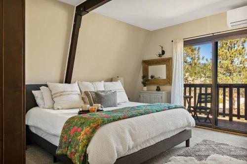 a bedroom with a large bed and a balcony at Larks Nest in Big Bear Lake in Big Bear Lake