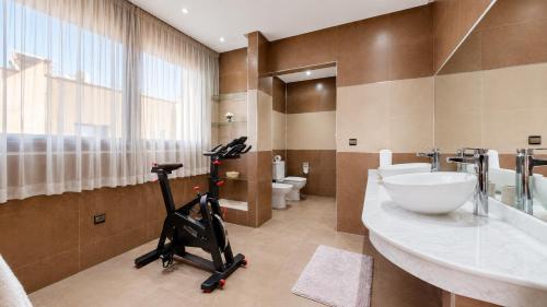 a bathroom with a exercise bike in the middle of it at Villa Amroth in Marrakesh
