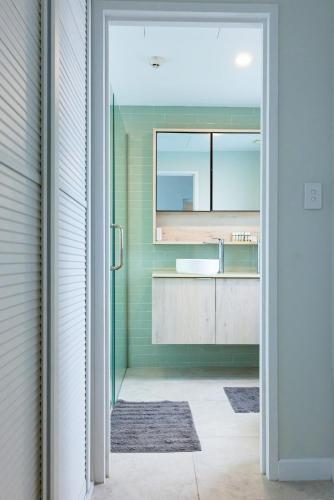 a bathroom with a sink and a mirror at 403 - Suva City Views Oceanfront Large Balcony in Suva
