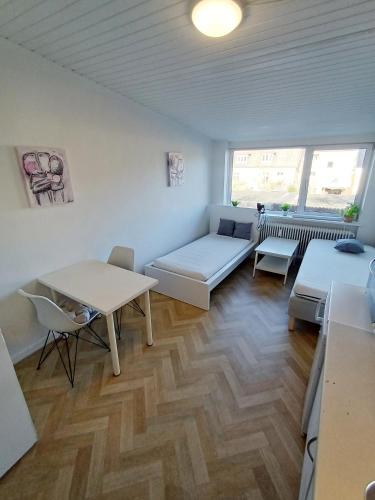 a living room with a couch and a table at Double room 1 with Free Parking in Nørresundby