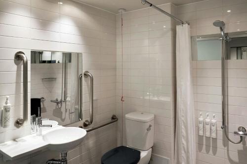 a bathroom with a toilet and a sink and a shower at Four Points Flex by Sheraton Cardiff in Cardiff
