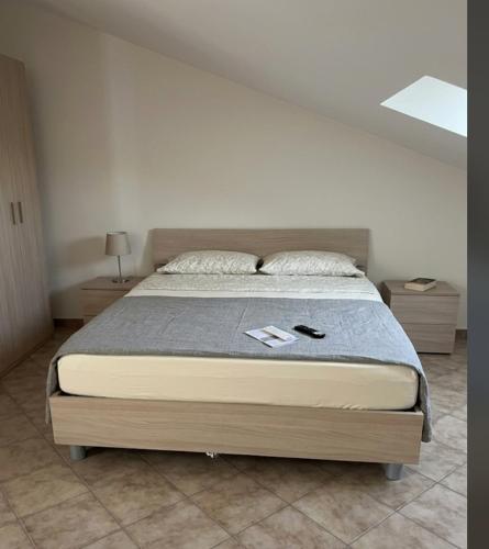 a large bed in a bedroom with two night stands at Il piccolo artista b&b in Naso
