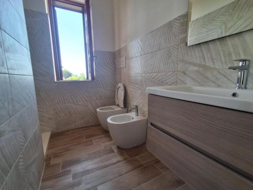 a bathroom with a toilet and a sink at Il piccolo artista b&b in Naso