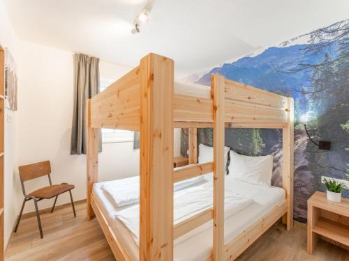 a bunk bed in a room with a mountain mural at Chalet Sylvia in Krimml
