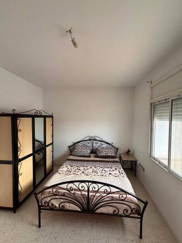 a bedroom with a large bed in a room at Le bienvenu in Sousse