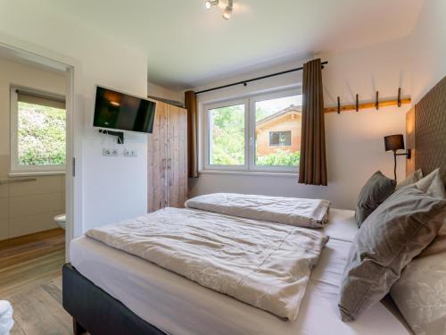 a bedroom with two beds and a window at Werfenblick in Werfenweng