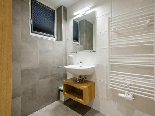a bathroom with a sink and a mirror at Hirnreit in Leogang